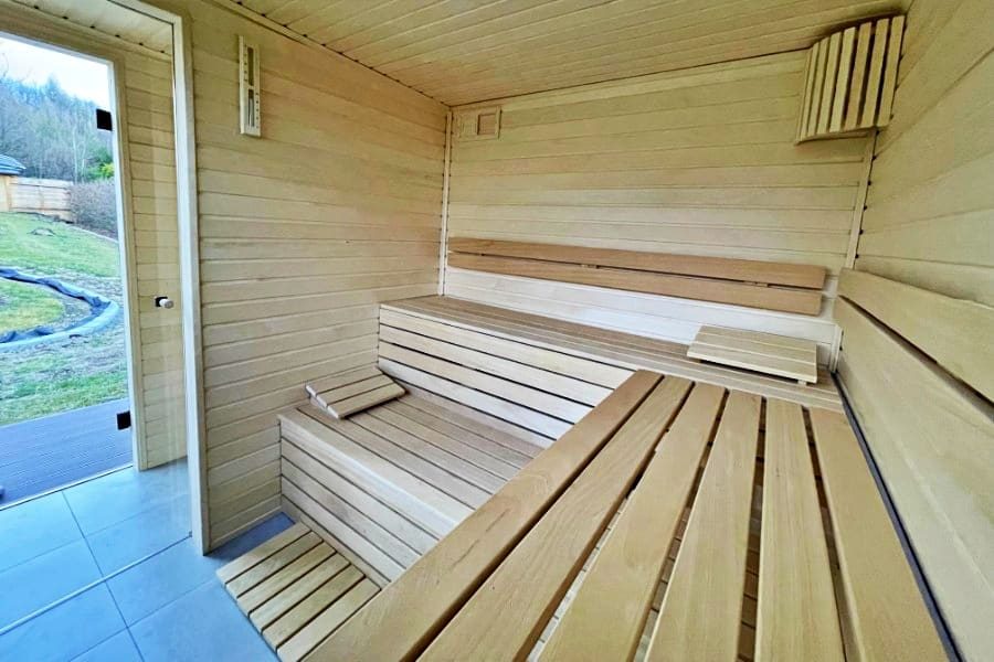 Dřevěné lavice ve venkovní sauně